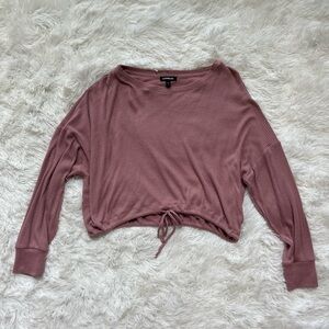 Express light pink top with adjustable string for customized wear.